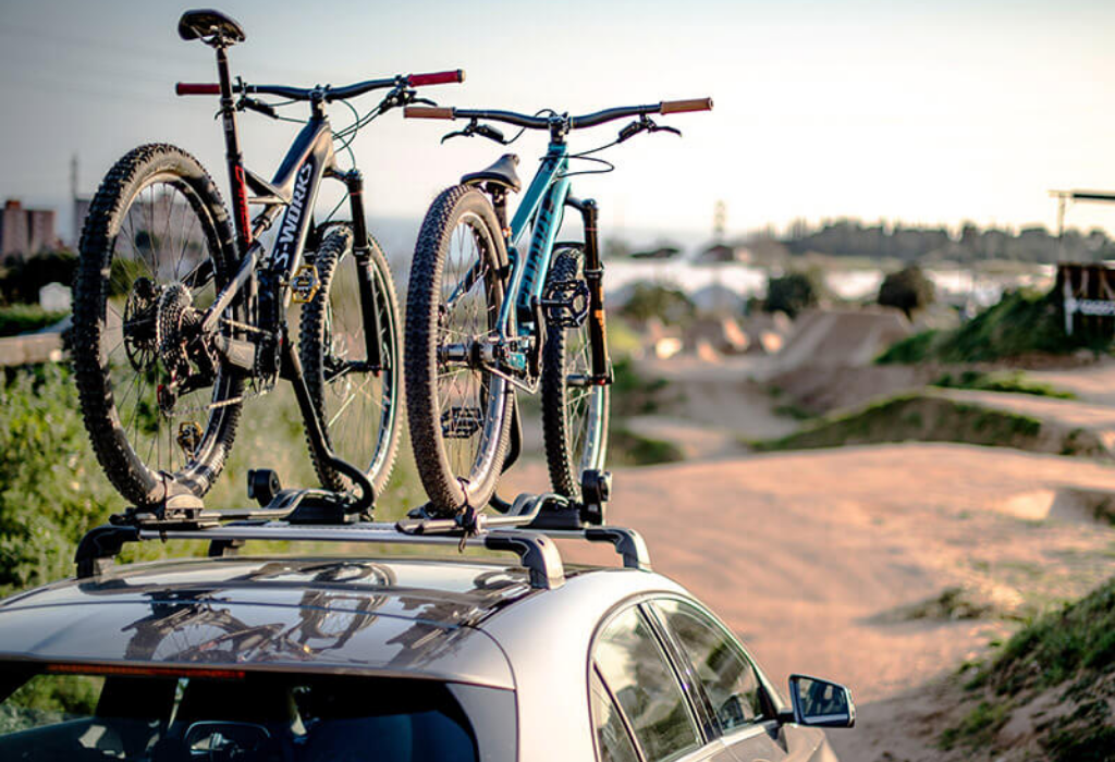 Bikes mounted to the roof of a car using a thule roof bike rack